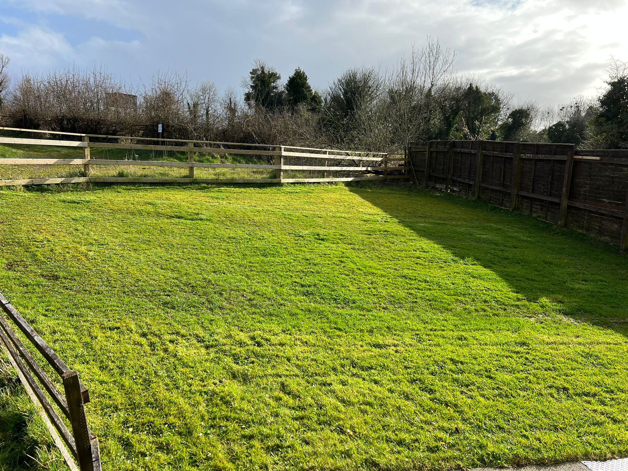 Neatly cut lawn with wooden fencing